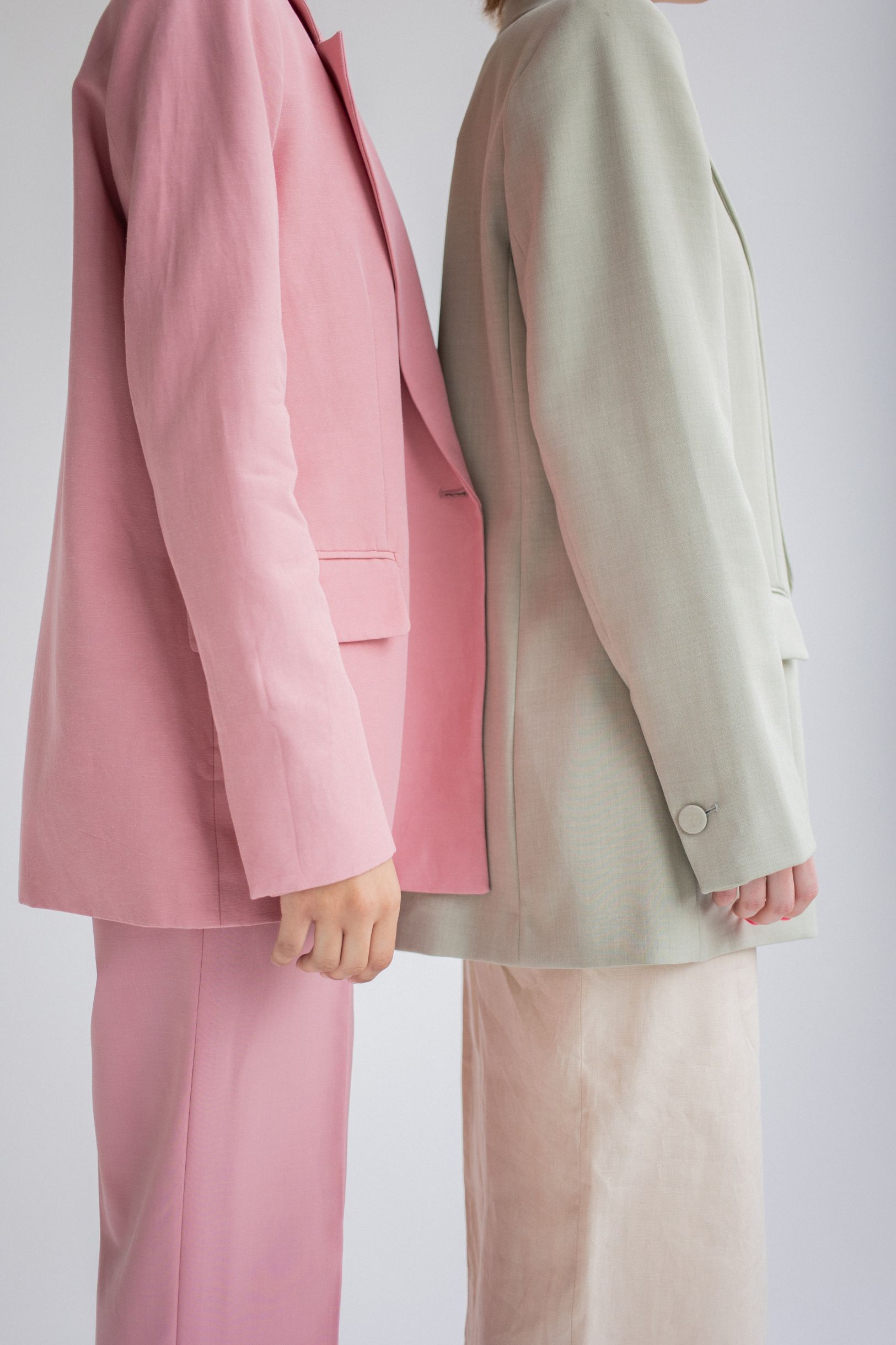 Two female entrepreneurs wearing pink and olive suits